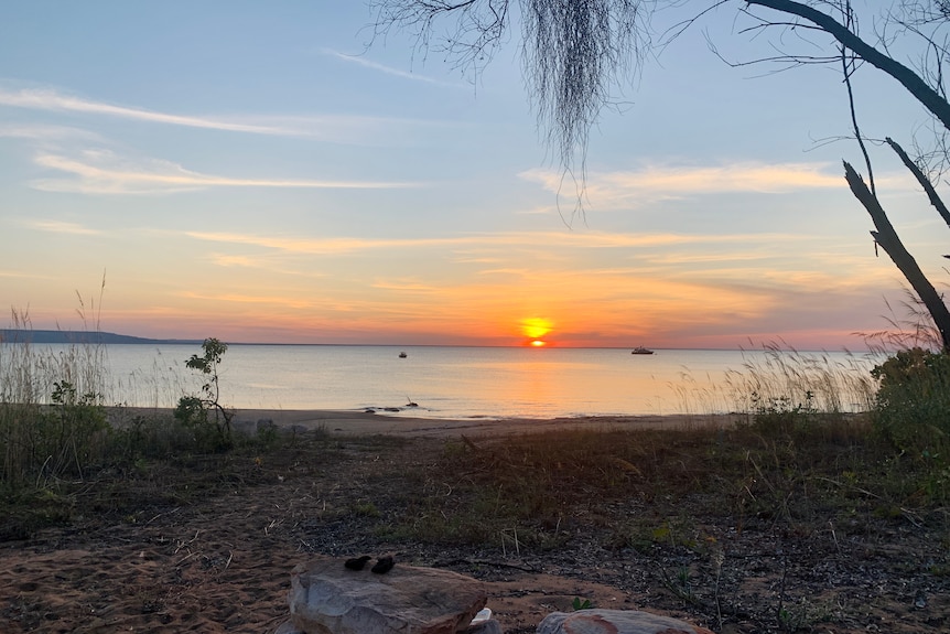 sunsets on water at beach