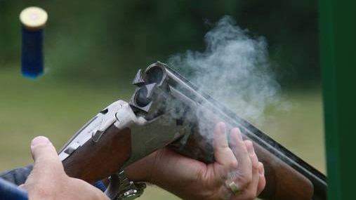 A shell is ejected after a shotgun is fired.