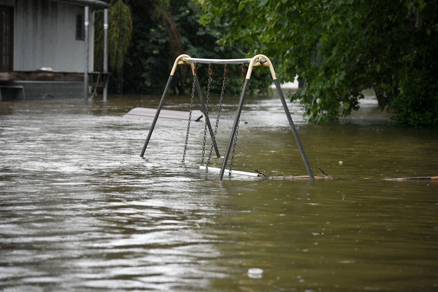 The top of a swing set that has been inundated in a flood.