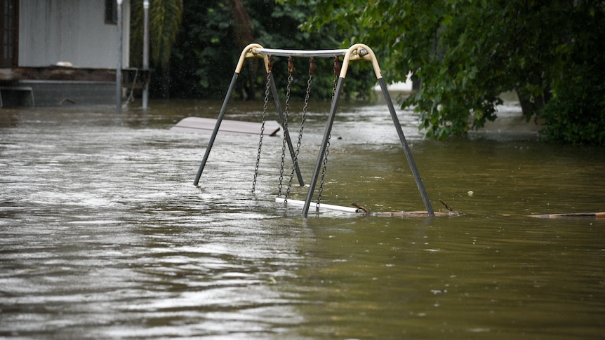 The top of a swing set that has been inundated in a flood.