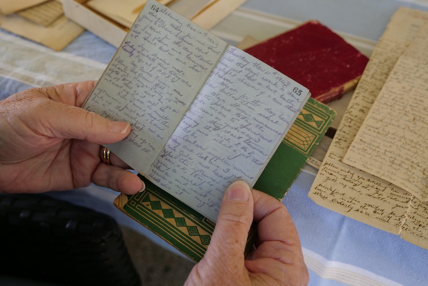 A close up of an old diary with tiny handwriting.