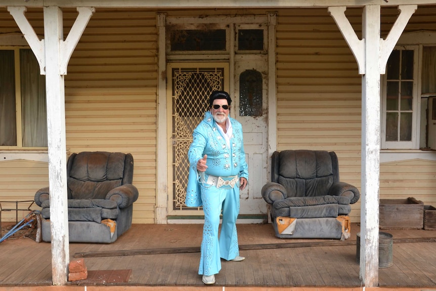 Mayor of Parkes, Ken Keith, dressed as Elvis on the front veranda of his home.