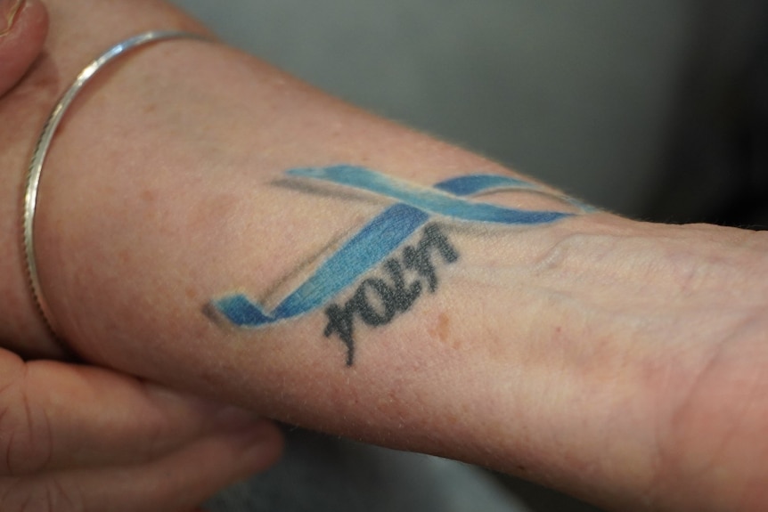 A blue ribbon tattoo