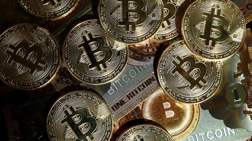 Golden coins with the Bitcoin logo on it are pictured.