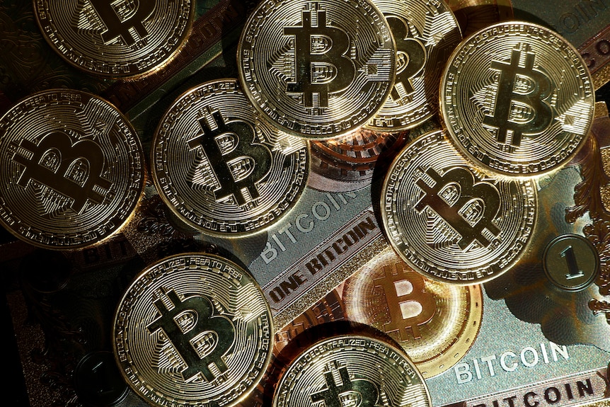 Golden coins with the Bitcoin logo on it are pictured.