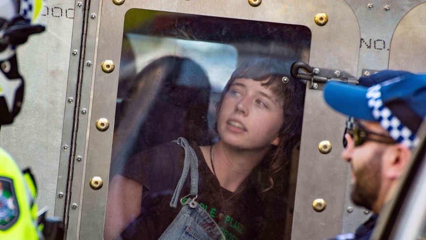 Extinction rebellion protester in a paddy wagon