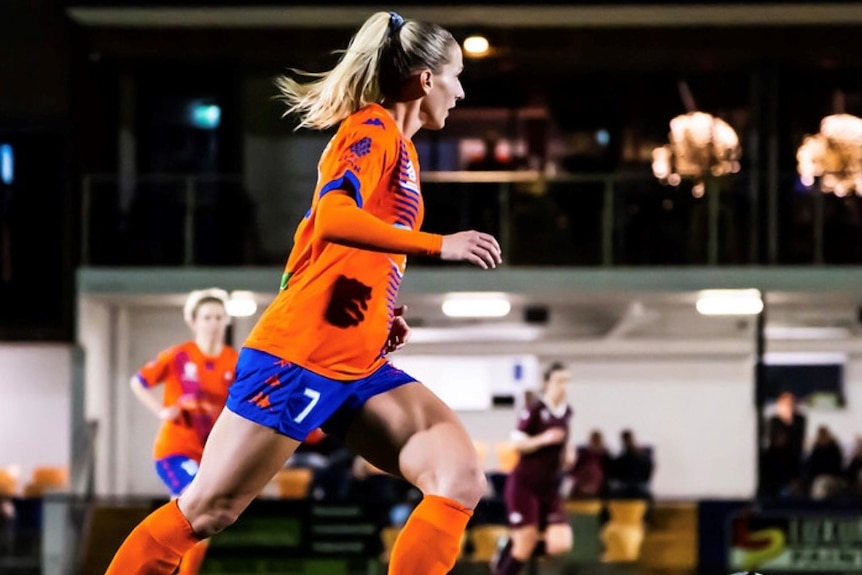 woman playing soccer