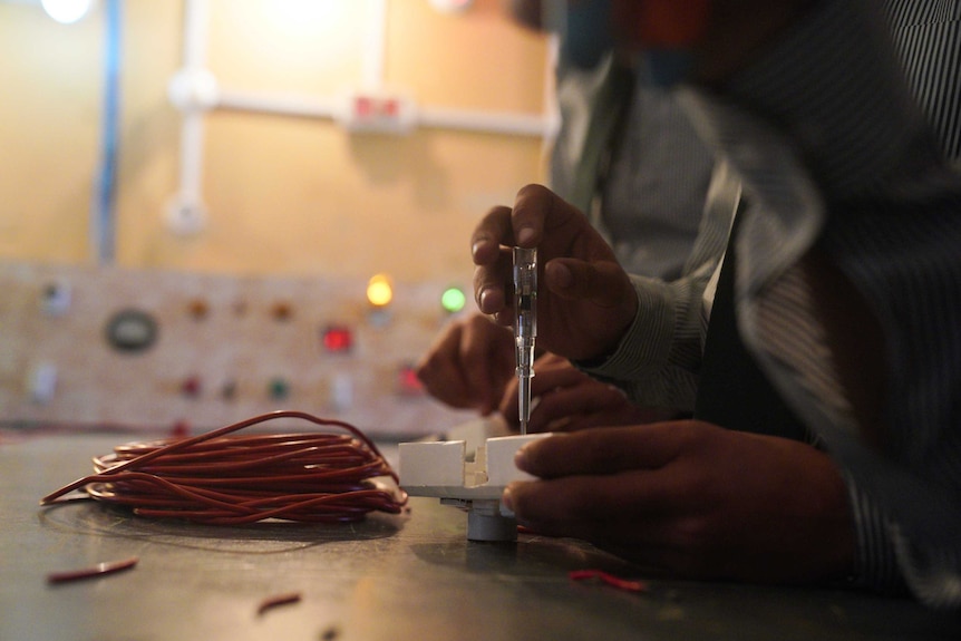 A boy fixes a light switch