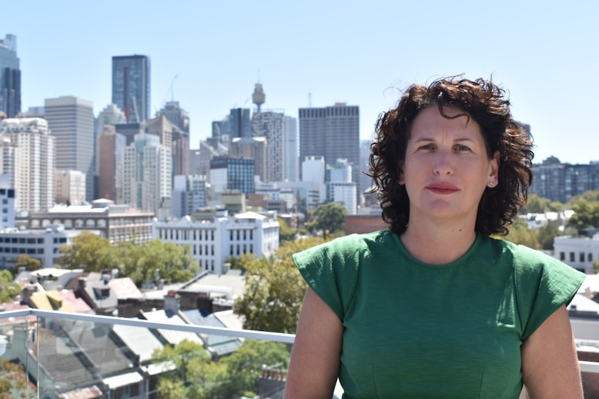 Portrait of National Secretary of the Community and Public Sector Union secretary, Melissa Donnelly, in front of Sydney skyline 