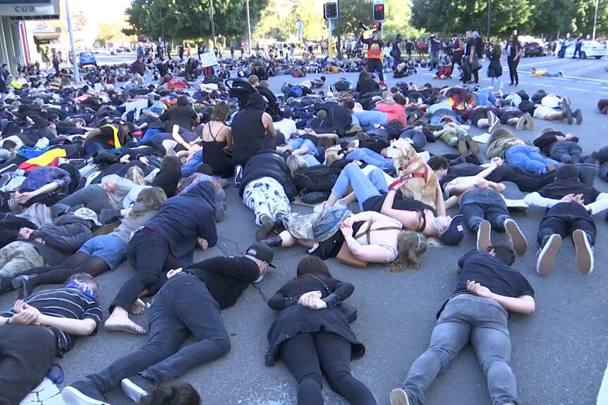 Hundreds of people laid down at the intersection of King and Darby Streets