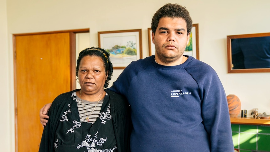 A photo of a woman and a young man standing next to each other.