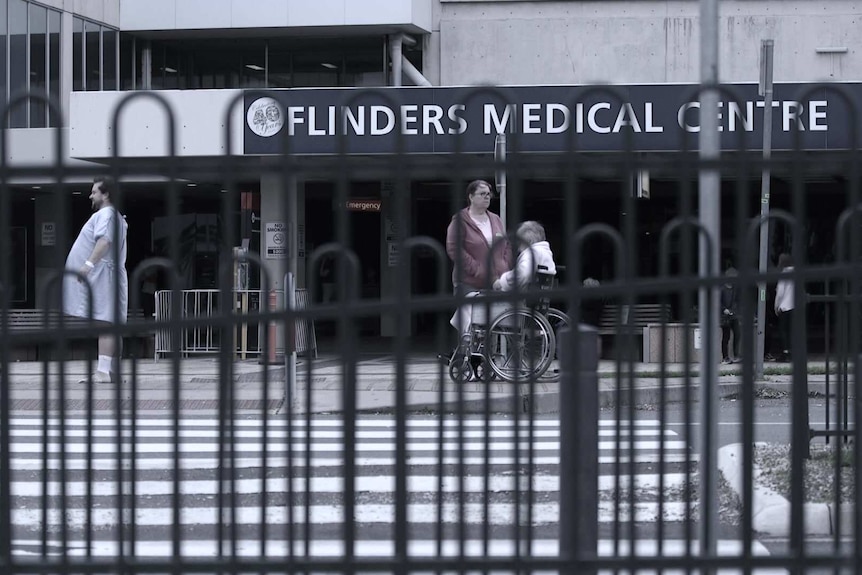 The front of a grey building with the words 'Flinders Medical Centre' displayed on it