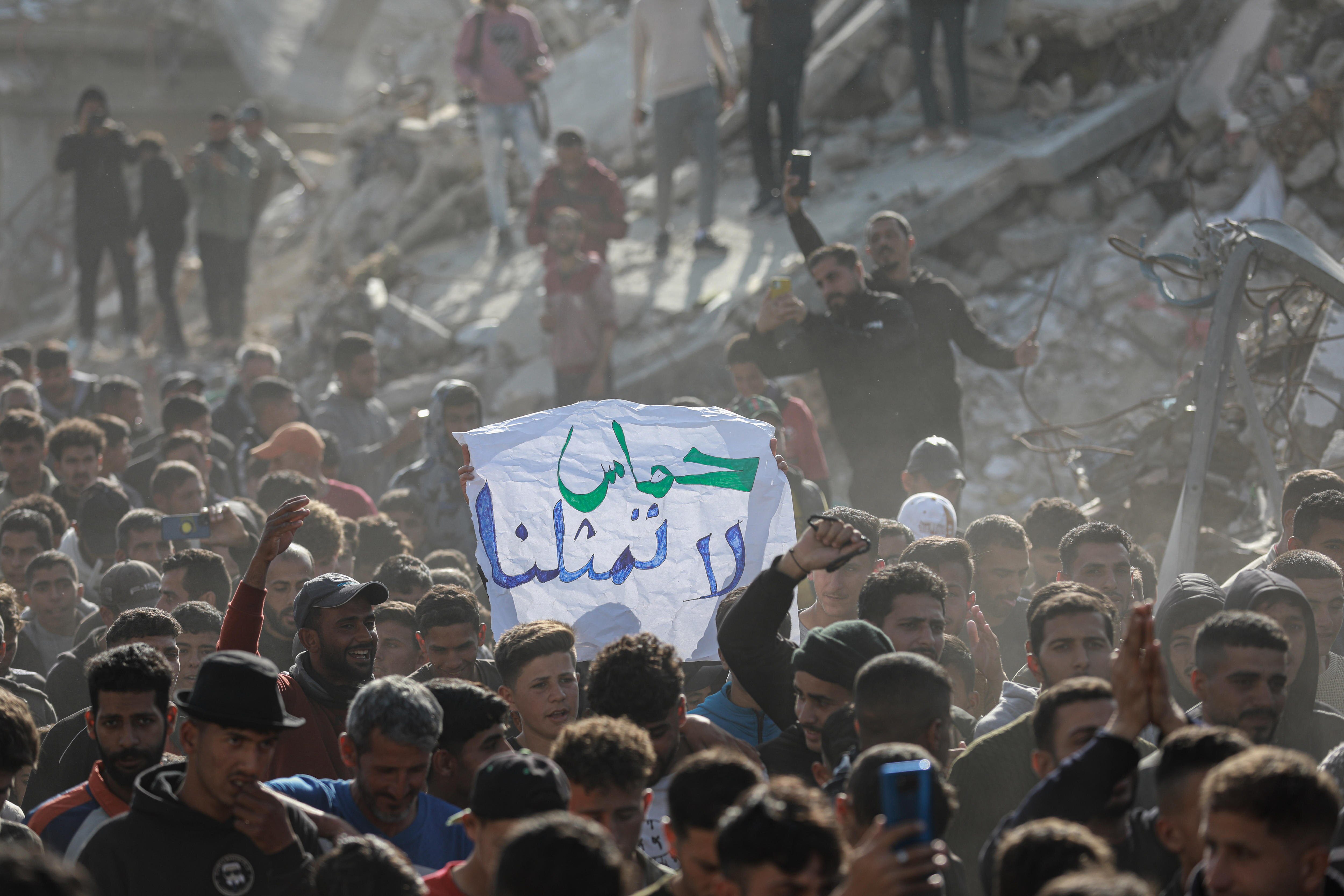 A protester carries a sign that reads "Hamas does not represent us" in Gaza.