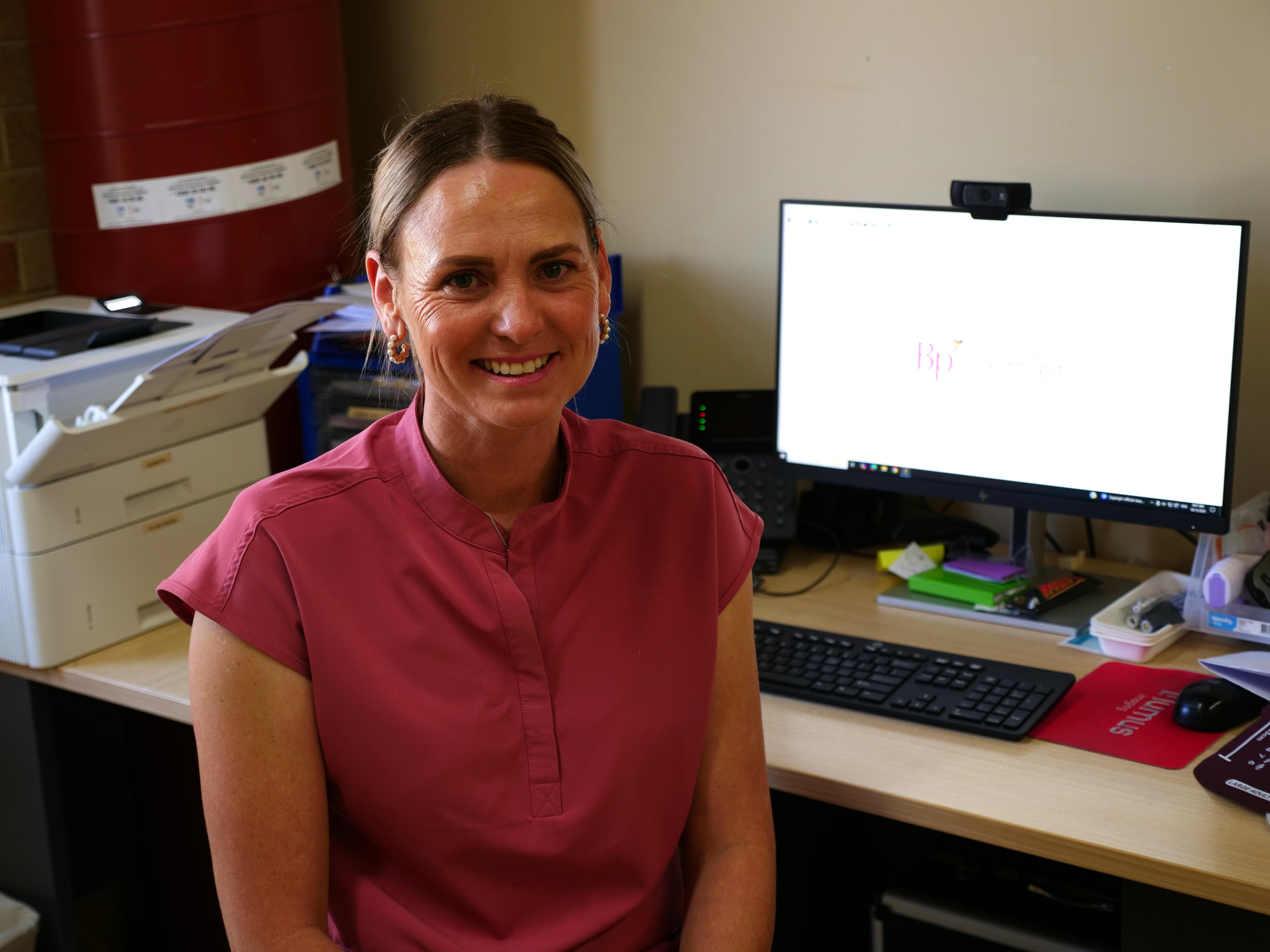 Skye Bradford sentada em sua mesa 