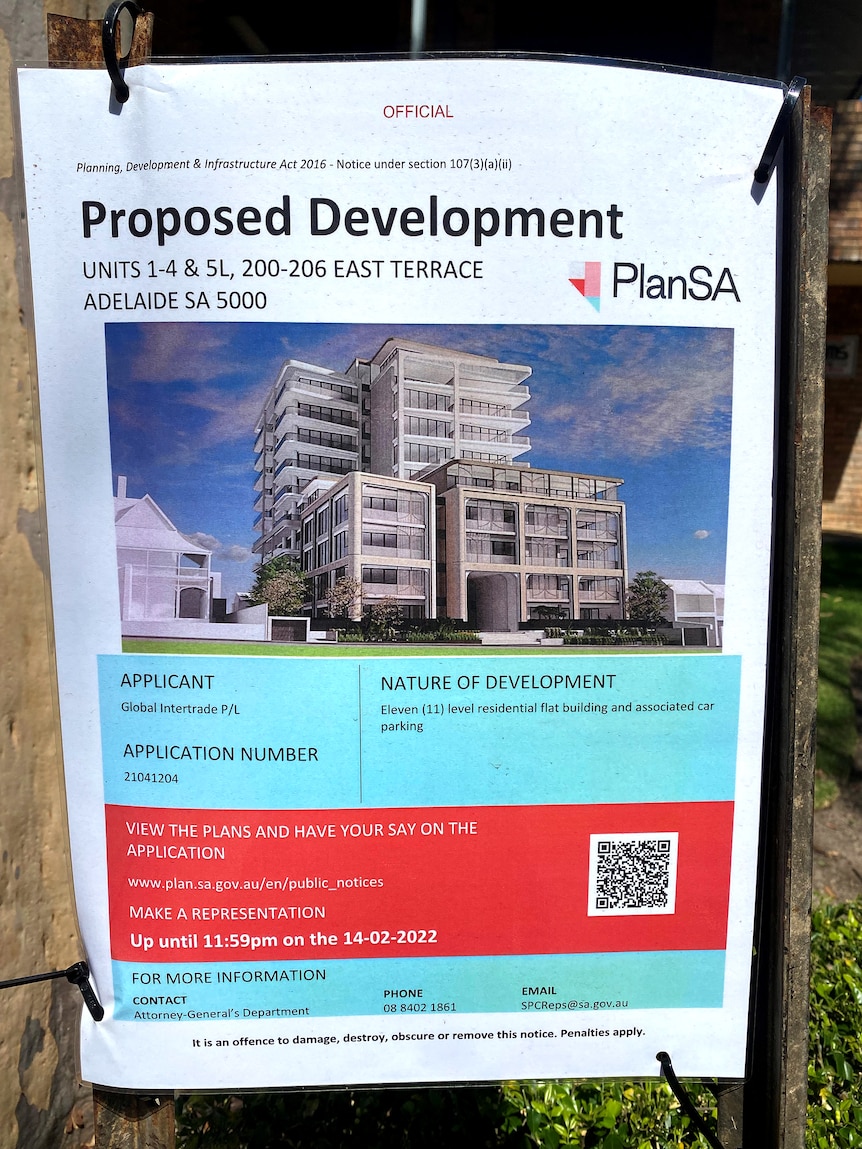 A notice about a proposed development fastened to a post.
