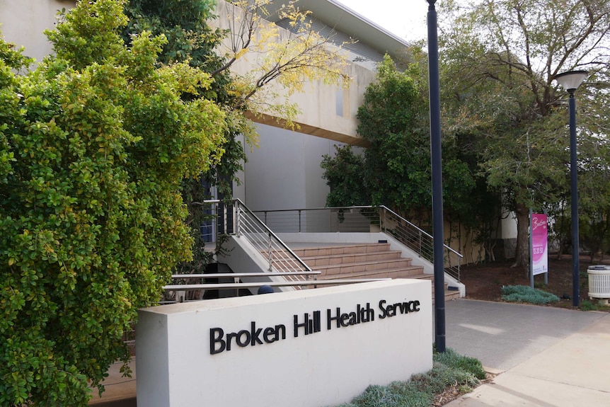 A shot from the footpath of stairs leading to an entry and a sign reading Broken Hill Health Service.