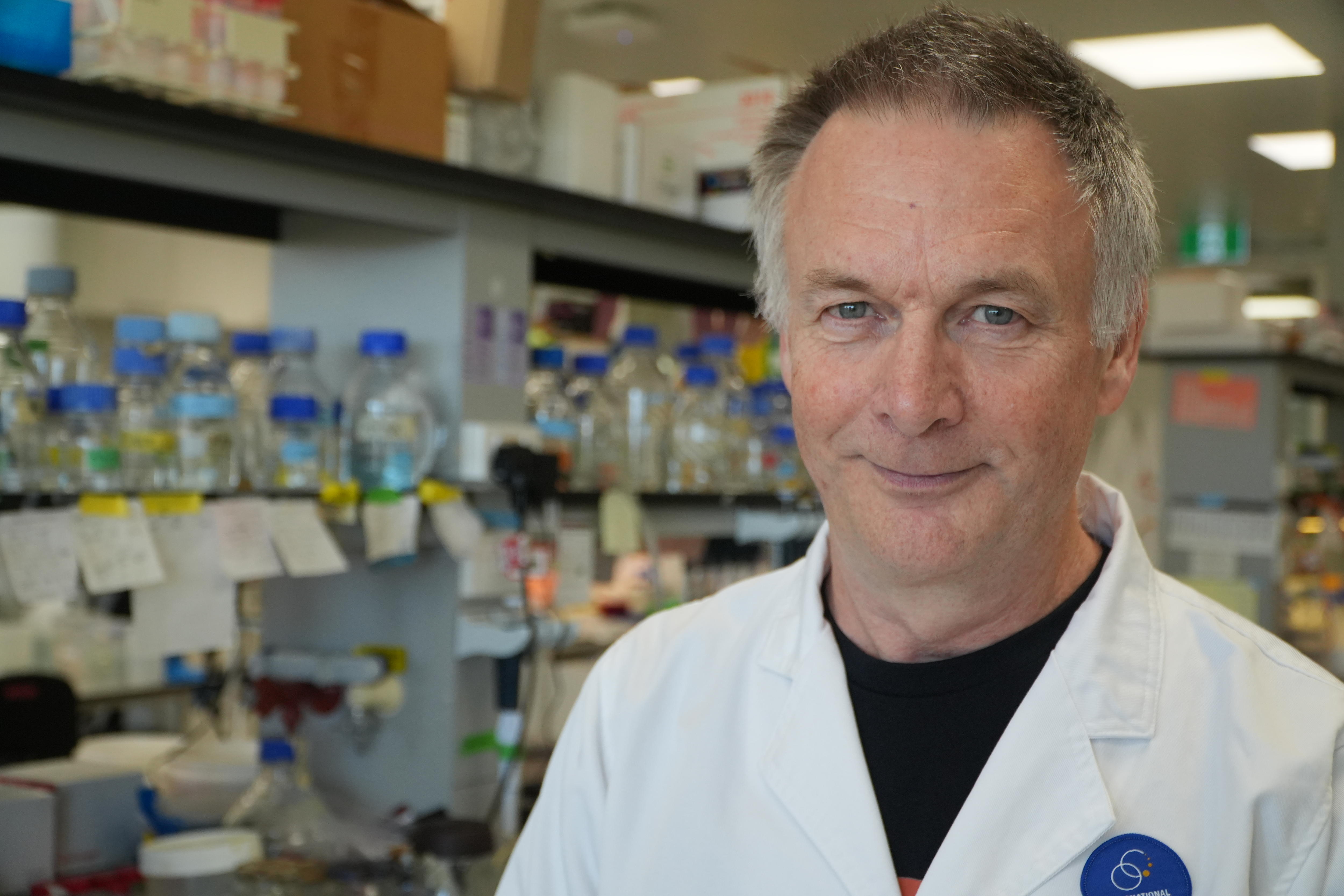 A head and shoulder shot of a smiling Professor Small wearing a lab coat.