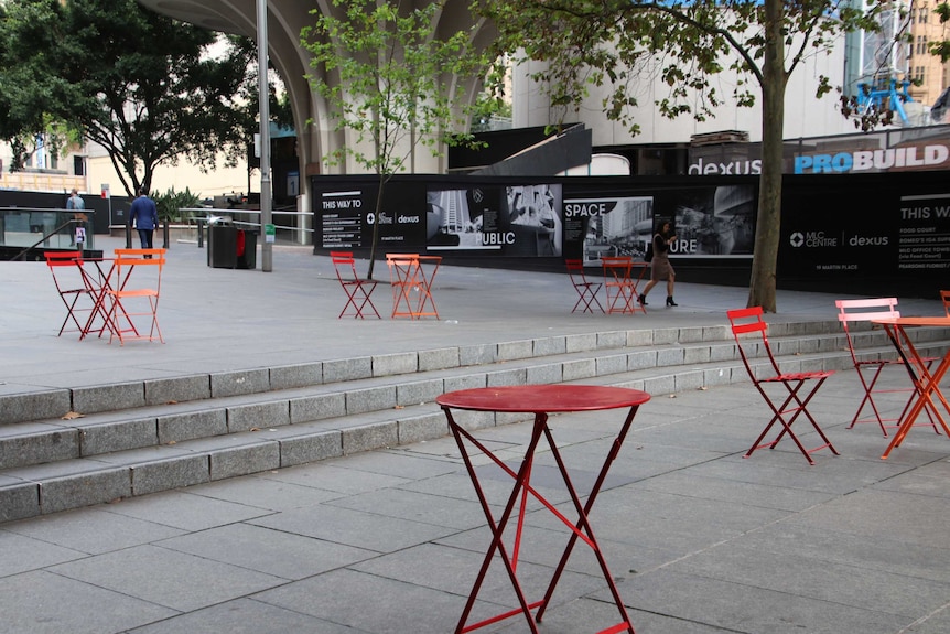 Empty chairs and tables in Martin Place