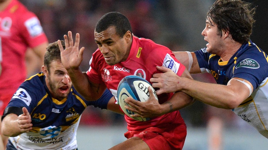 No way through ... the Reds' Will Genia tries his luck against the relentless Brumbies defence.