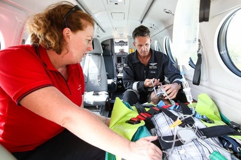 Man and woman with patient on small aircraft