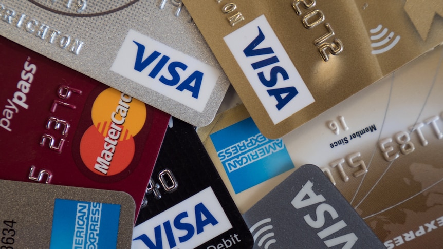 A photo of credit cards strewn on a table.