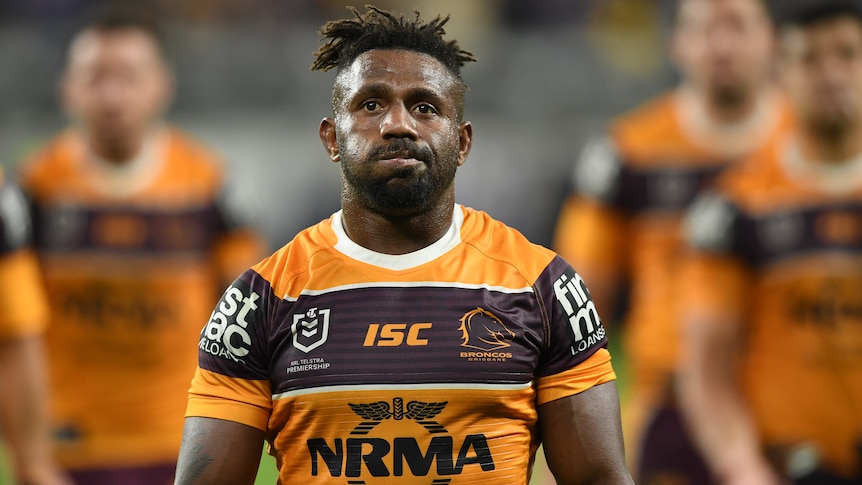 An NRL player during his time with the Brisbane Broncos walks from a playing field in 2019.