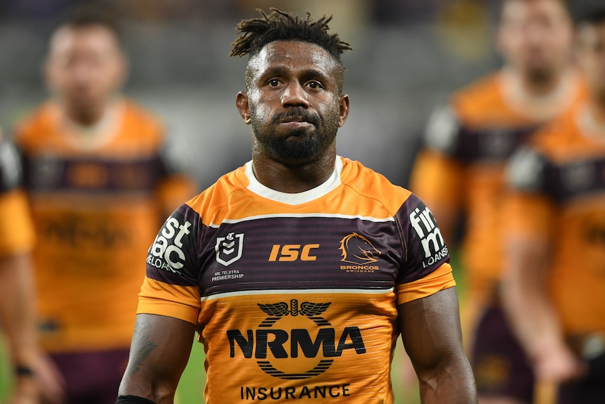 An NRL player during his time with the Brisbane Broncos walks from a playing field in 2019.
