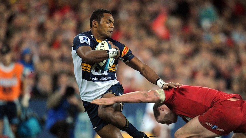 Eat my dust ... the Brumbies' Henry Speight accelerates past the Reds defence at Lang Park.