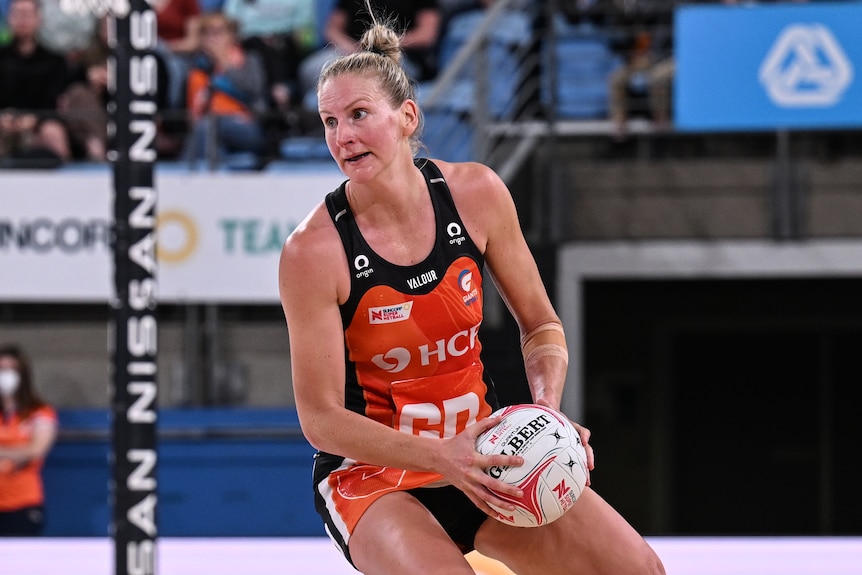 A Giants Super Netball player holds the ball during a match against West Coast Fever.
