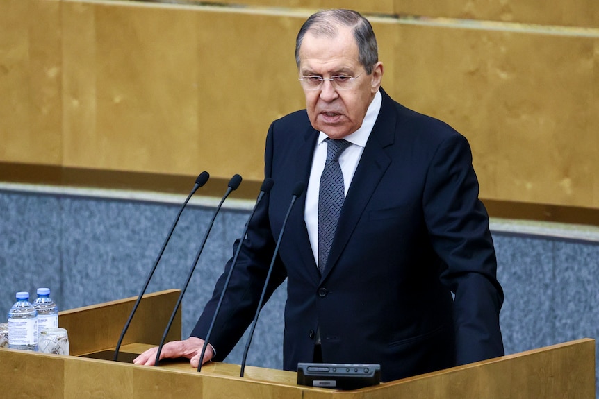 Sergey Lavrov stands at a lectern addressing the State Duma.