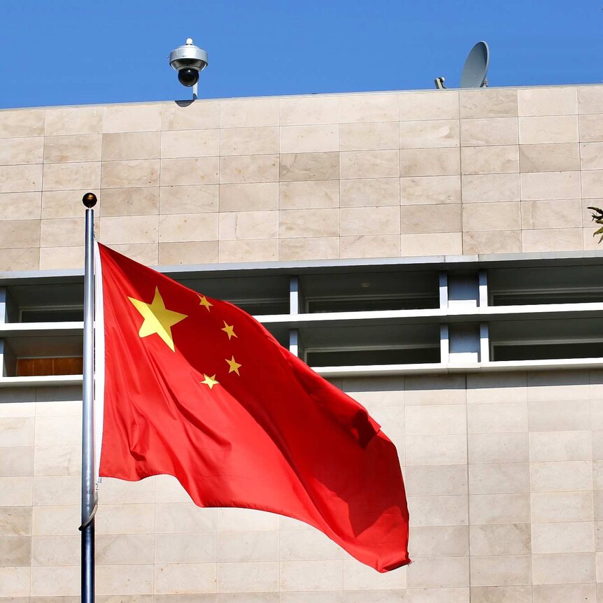A Chinese flag flutters in wind before the Chinese Consulate building in East Perth on a sunny day.