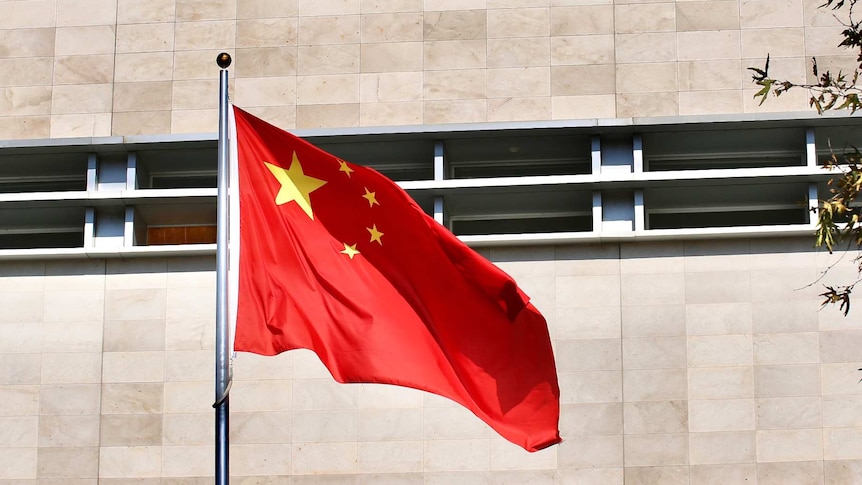 A Chinese flag flutters in wind before the Chinese Consulate building in East Perth on a sunny day.