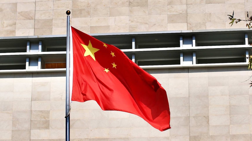 A Chinese flag flutters in wind before the Chinese Consulate building in East Perth on a sunny day.