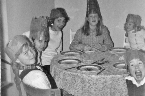 Black-and-white photo of kids at a Christmas dinner table