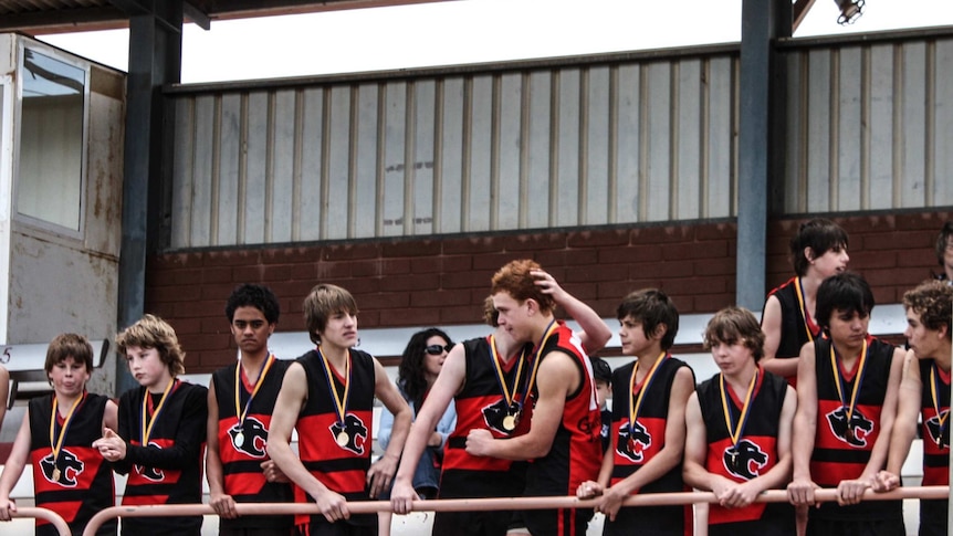 junior football medals being awarded