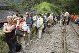 A group of tourists wait for evacuation near the Inca ruins of Machu Picchu