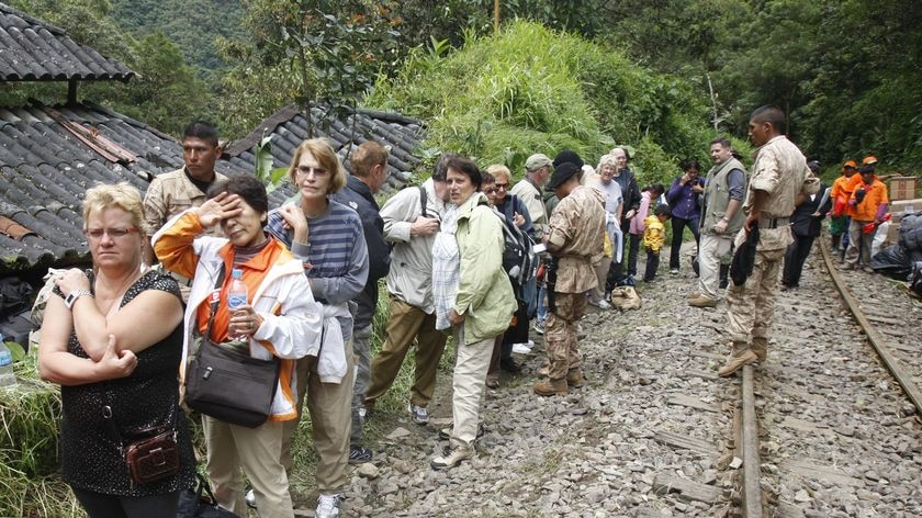 A group of tourists wait for evacuation near the Inca ruins of Machu Picchu