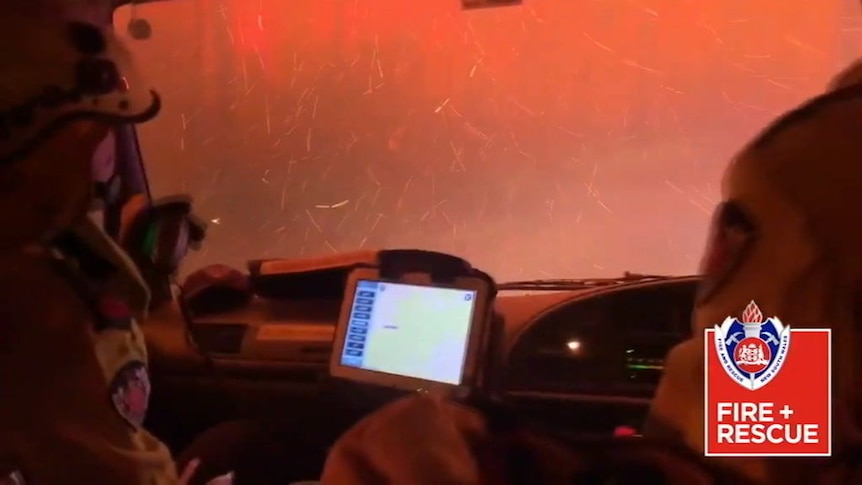 The view from the front window of a fire truck of an ember storm.