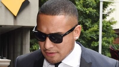 a man in a suit and sunglasses wearing diamond earrings