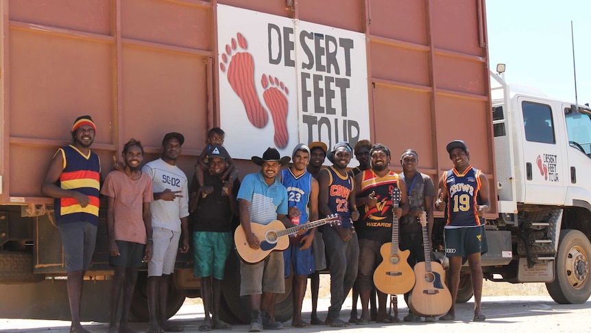 Young men stand in front the Desert Feet truck.