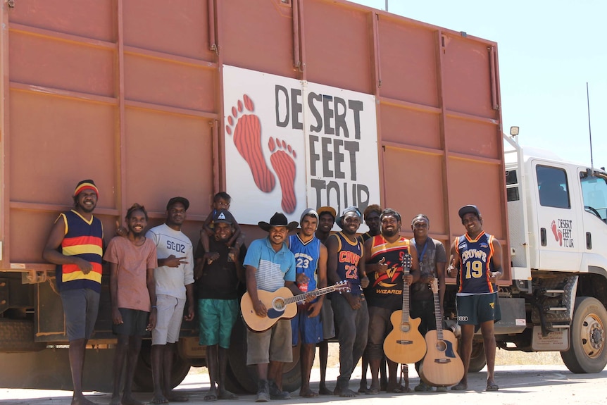 Young men stand in front the Desert Feet truck.