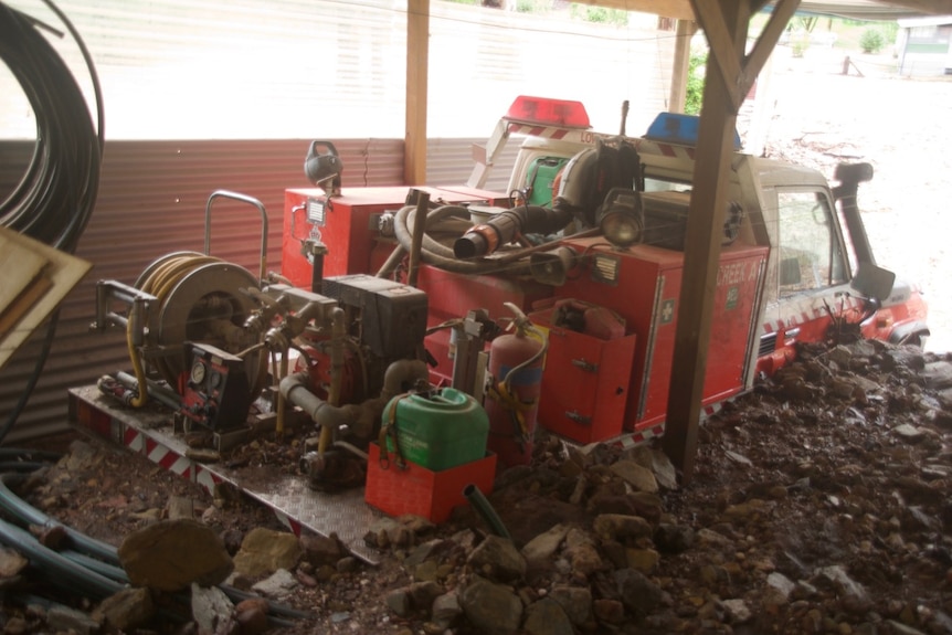 Kay Bridge's fire tanker has been covered with mud and rocks in a post-bushfire deluge.