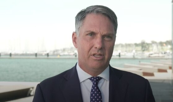 A man with grey hair in a suit.