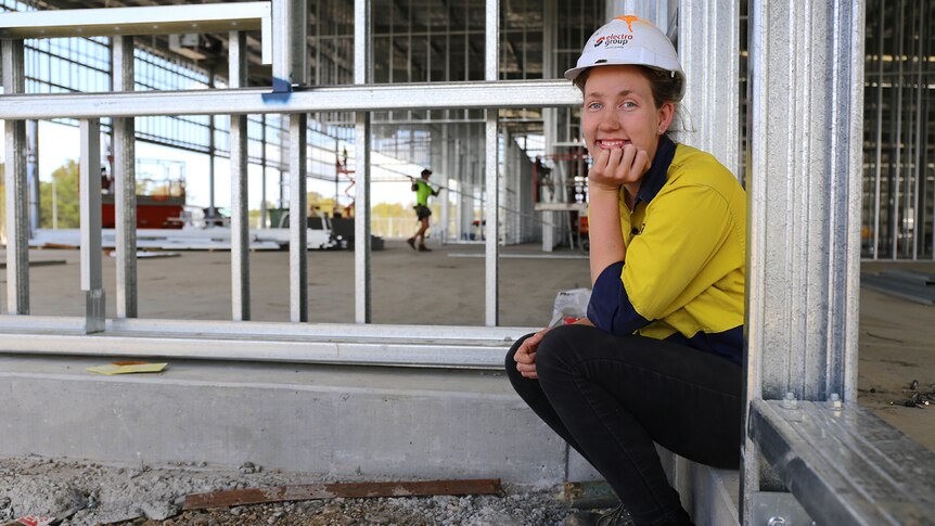 Maddison Carr sits on work site