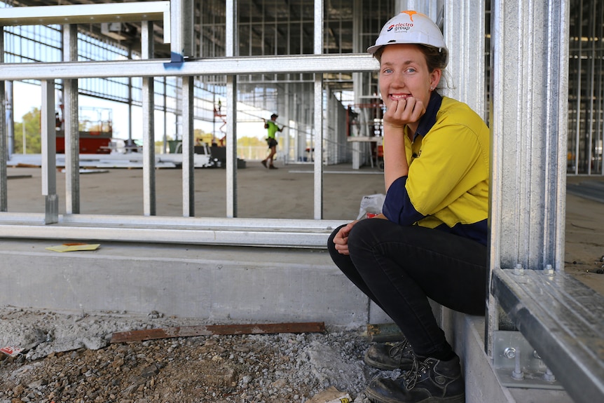 Maddison Carr sits on work site