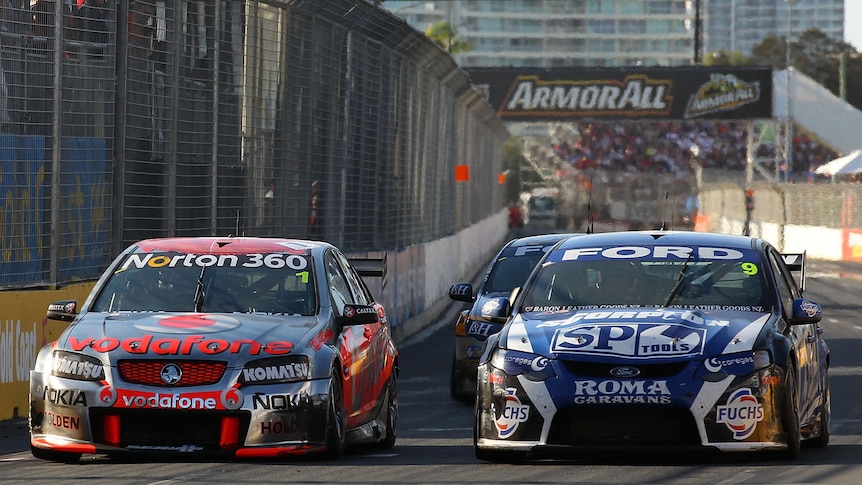 Jamie Whincup battles for position with Shane Van Gisbergen on the final lap at Surfers Paradise