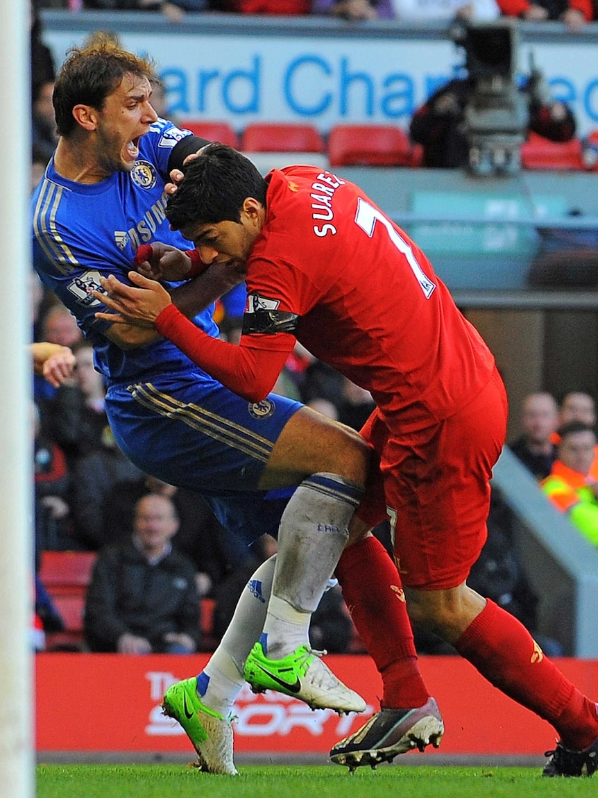 Moment of infamy ...  Liverpool striker Luis Suarez (R) bites Chelsea's Branislav Ivanovic.