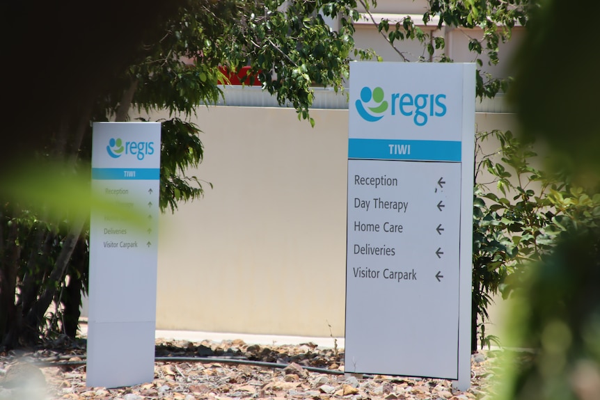 Signs pointing to sections of the Regis Tiwi Gardens aged care facility. 