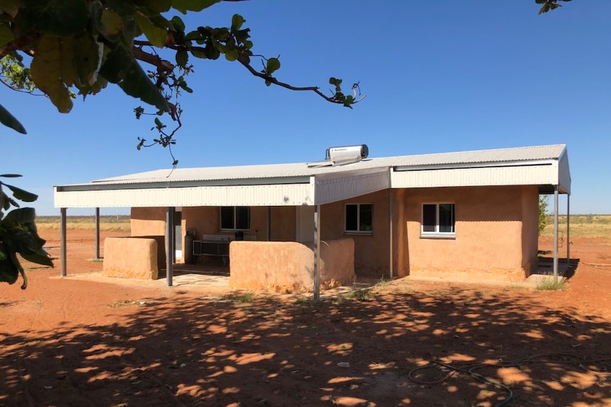 Modern home in desert with angled skillion roof and rendered walls