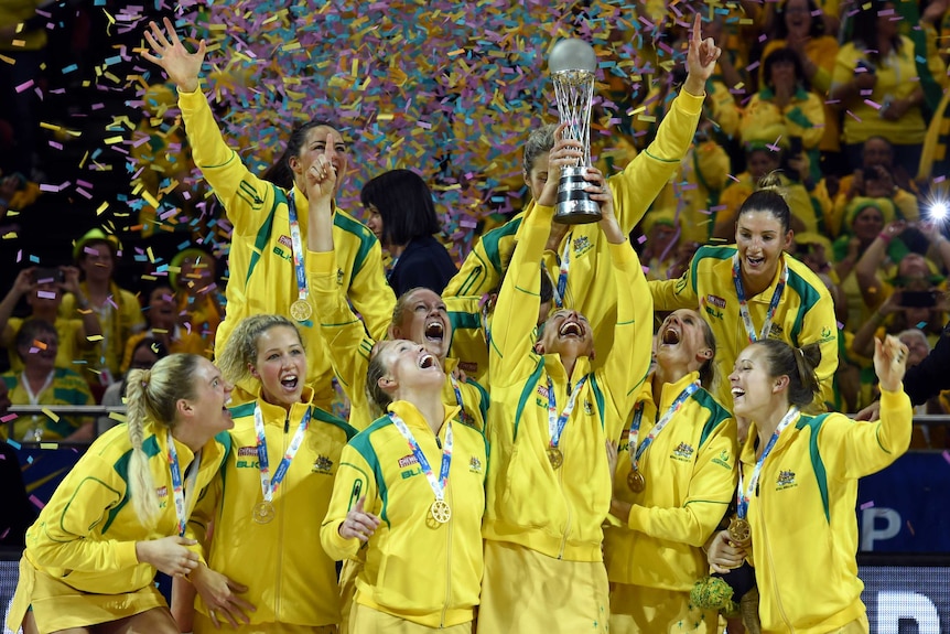 Australian netballers celebrate as their captain lifts the Netball World Cup trophy after winning the final in Sydney in 2015.
